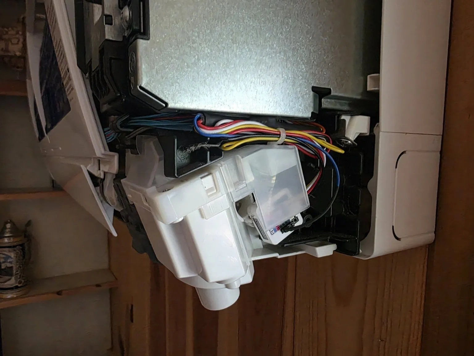 AtomS3 Lite CN105 controller installed in the protected low-voltage area of a mini-split indoor head.